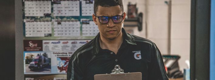 Man Holding Clipboard Inside Room